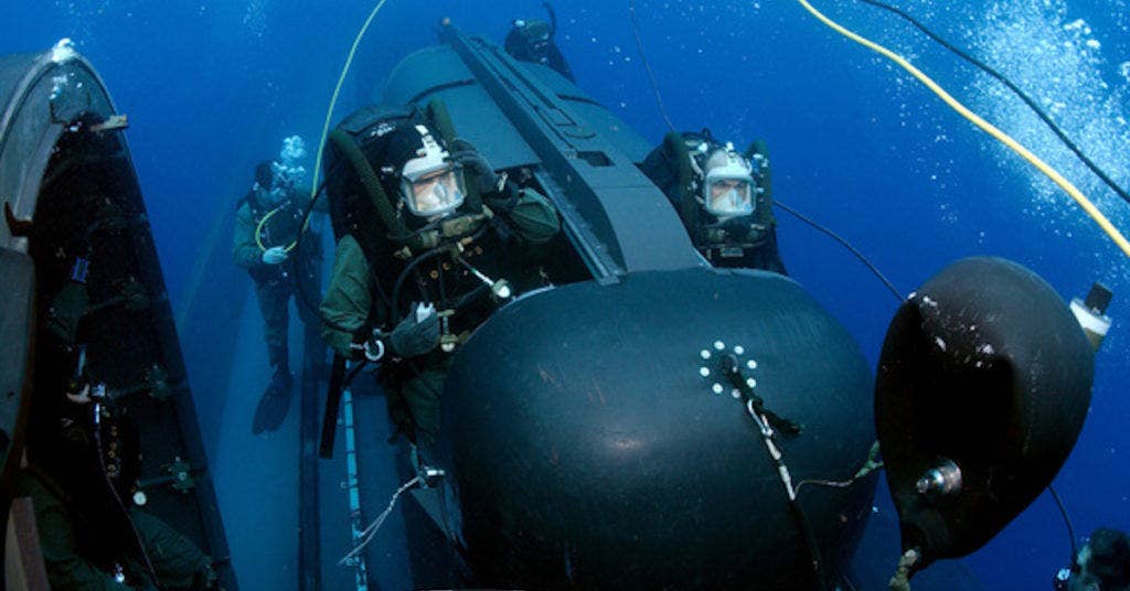 Members of SEAL Delivery Vehicle Team Two (SDVT-2) prepare to launch one of the team's SEAL Delivery Vehicles (SDV) from the back of the Los Angeles-class attack submarine USS Philadelphia (SSN 690) on a training exercise. (U.S. Navy photo by Chief Photographer's Mate Andrew McKaskle (RELEASED)