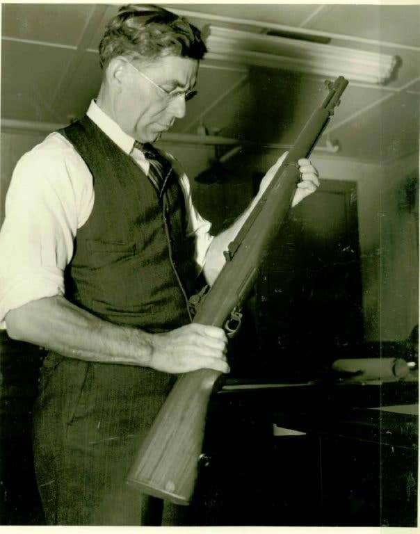Firearms designer John C. Garand and his M1 (Photo via Wikimedia)
