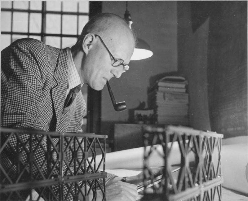 Donald Bailey carefully examines one of his bridge designs. (Source: Wikipedia Commons)