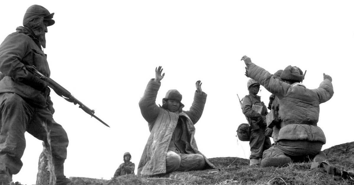 Men of the 1st Marine Division capture Chinese Communists during fighting on the central Korean front, Hoengsong. Photo under Public Domain.