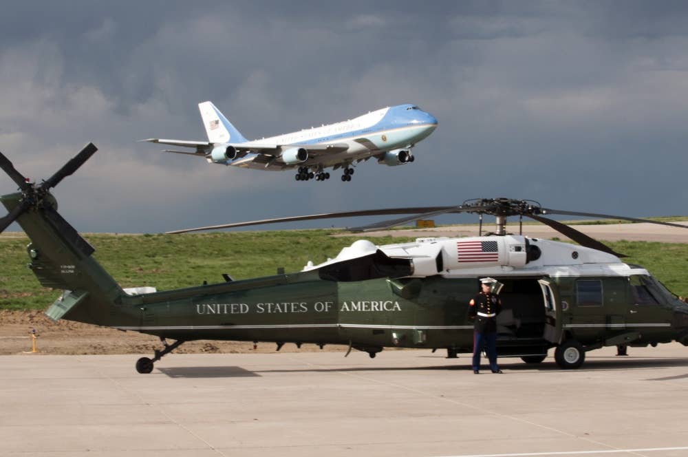 A VH-60N White Hawk parked while a VC-25 takes off in the background (Photo US Air Force)