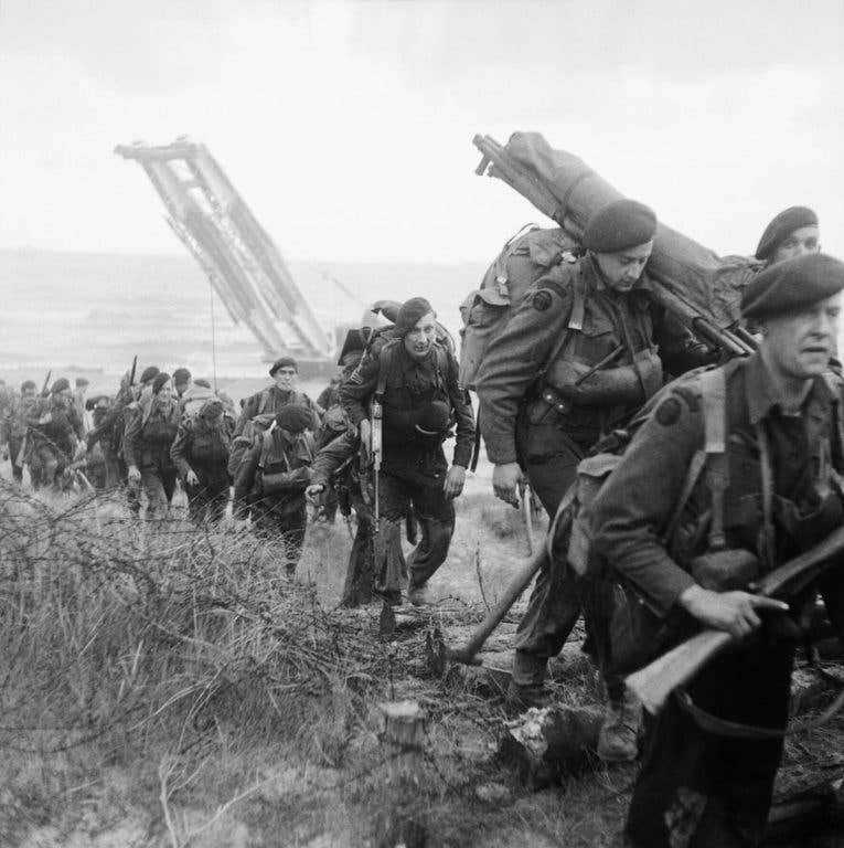 Royal Marine Commandos move inland from Sword Beach on the Normandy coast on June 6, 1944. (Photo: Capt. J.L. Evans, Imperial War Museums)