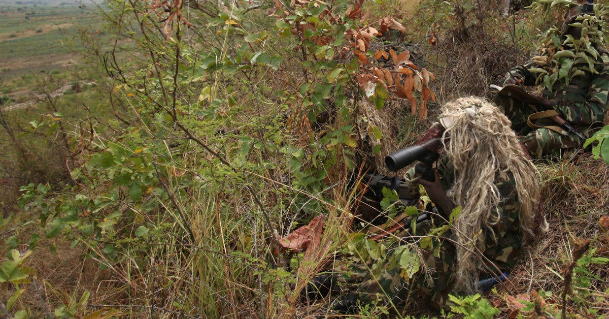Snipers with 1st Sapper Company, Burundi National Defense Force, observe enemy movement, donning field-made ghillie suits. USMC Photo by 1st Lt. Dominic Pitrone