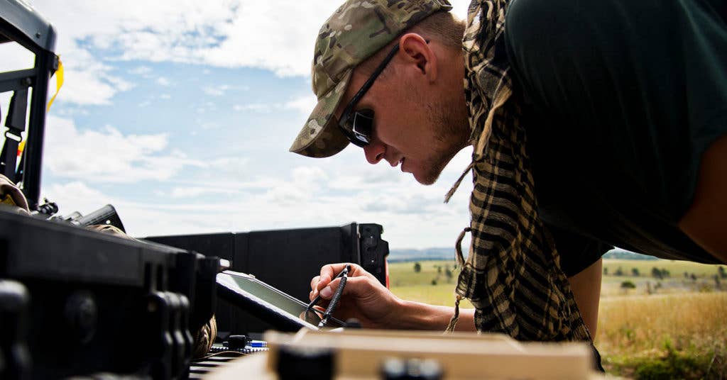 Staff Sgt. Leland Hastings, 919th Special Operations Security Forces Squadron, monitors the Raven-B, a four-by-four foot unmanned aerial system, through a laptop computer at Camp Guernsey, Wyo., Aug. 4. The 919th SOSFS brought the UAS to demonstrate its capabilities to other security forces units involved in a large field training exercise at the camp. The Raven-B has the ability to take photos, video in day or night, and even designate locations via an IR laser. It also provides coordinates, magnetic azimuths, and linear distances creating a birds-eye view to topographical map. (U.S. Air Force photo/Tech. Sgt. Sam King)