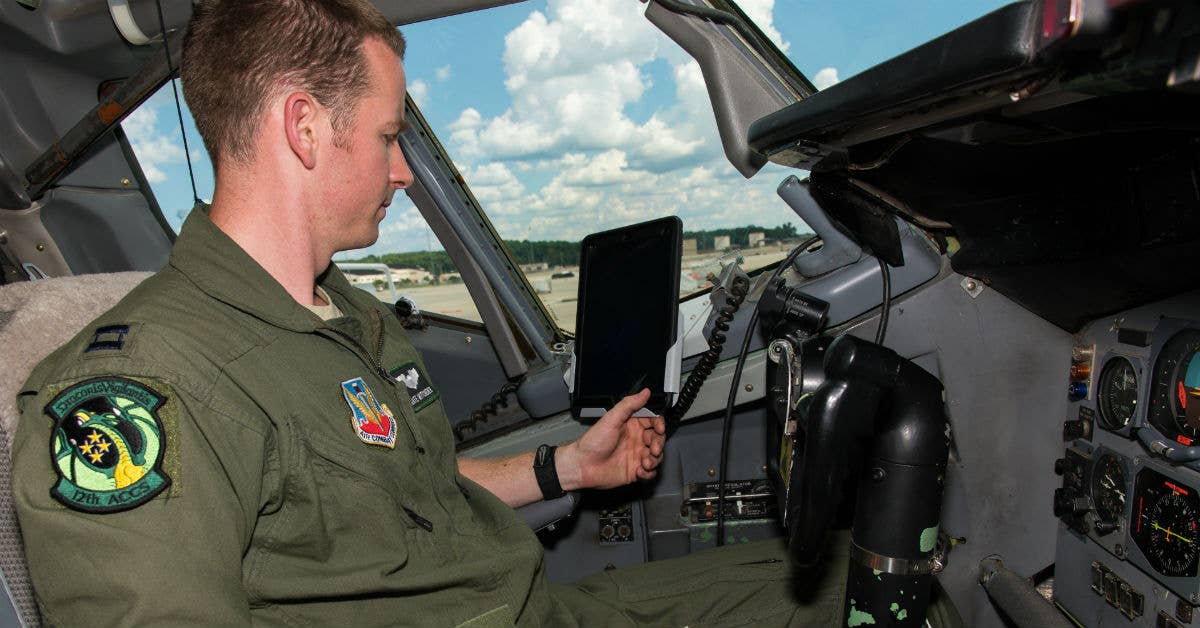 A pilot with the 461st Air Control Wing (ACW), inspects a new iPad holder designed for use on the E-8C Joint STARS. Photo by Senior Master Sgt. Roger Parsons.