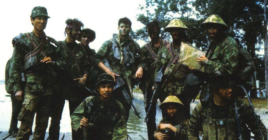 Navy SEALs in Vietnam. Note the Stoner 63 in the center. (National Archives)