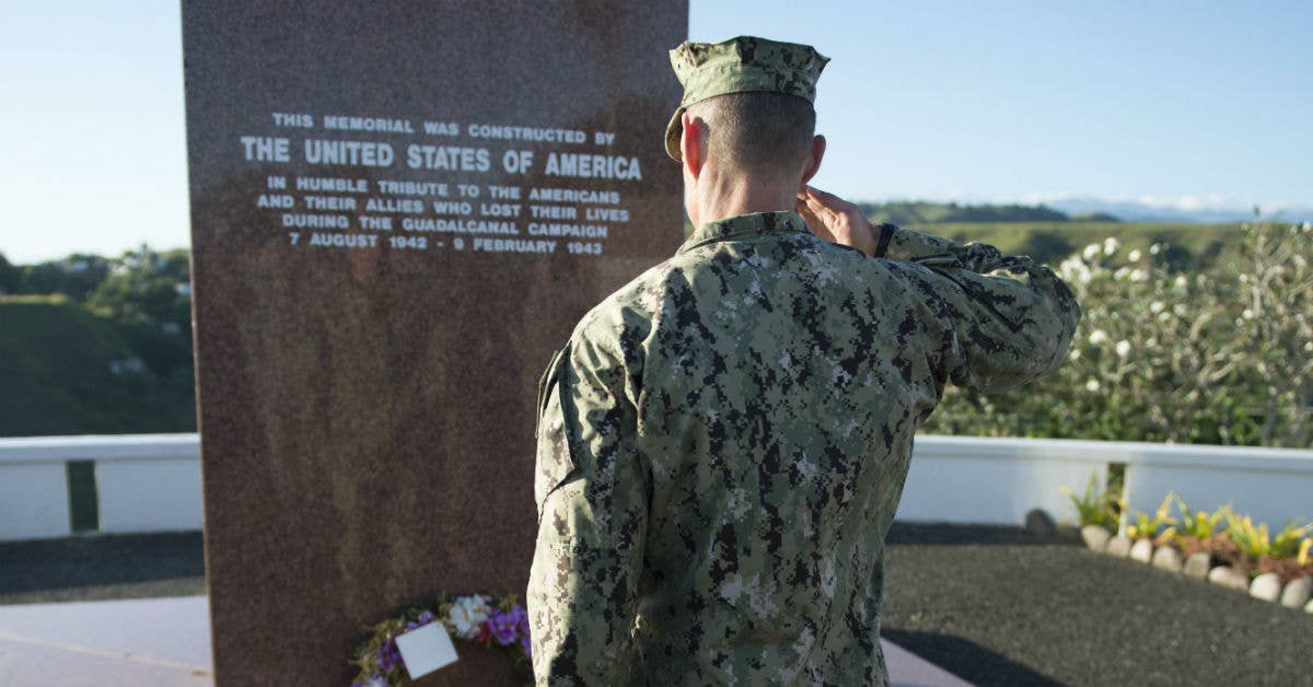 Commodore Task Force Forager, Capt. James Meyer, renders honors after placing a wreath at the Guadalcanal American Memorial. Navy photo by Mass Communication Specialist 1st Class Carla Burdt.