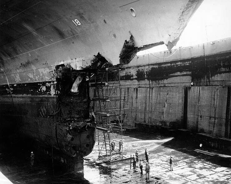 The U.S. Navy aircraft carrier USS Wasp (CV-18) in drydock at Bayonne, New Jersey, showing the damage to the carrier's bow from her 26 April 1952 collision with USS Hobson (DMS-26). Wasp collided with Hobson while conducting night flying operations in the Atlantic, en route to Gibraltar. Hobson was cut in two and sank, 61 men of her crew could be rescued, but 176 were lost. (US Navy photo)