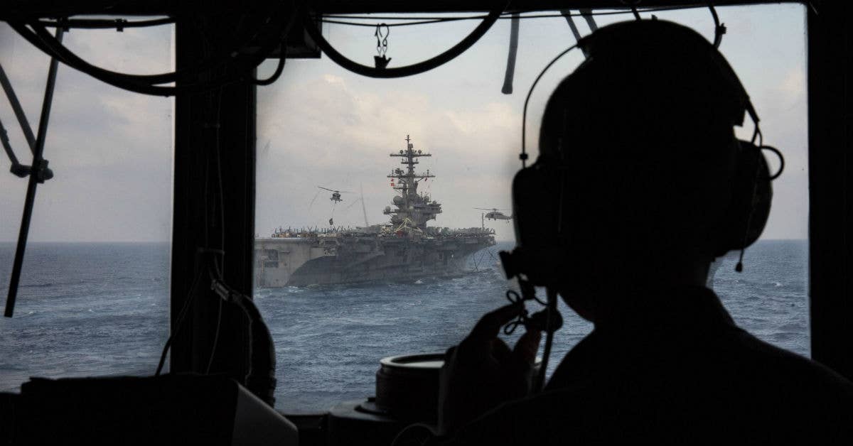 Commanding officer of the guided-missile cruiser USS Philippine Sea (CG 58) oversees operations from the bridge wing of the ship. Navy photo by Patrick I Crimmins.