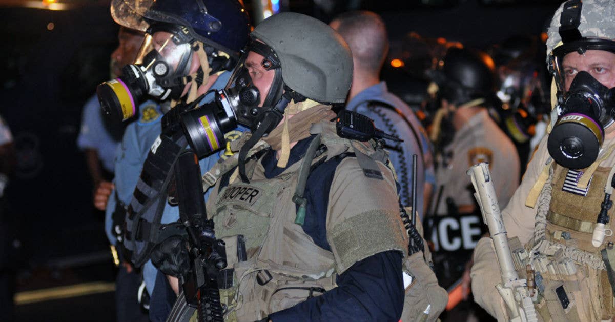 Police in tactical gear at the Ferguson riots, 2014. Wikimedia Commons photo by user Loavesofbread.