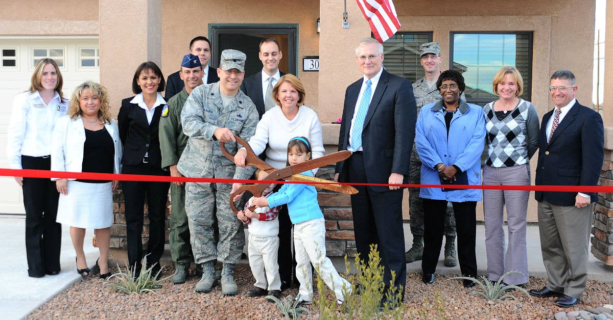 Lt. Col. William Walker 49th Material Maintenance Group and his family prepare to cut the ribbon on their new home at the Soaring Heights Communities ribbon cutting ceremony at Holloman Air Force Base.