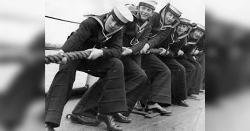 Young sailors aboard a ship play tug-of-war in their classic bell bottoms. (Source: Pinterest)