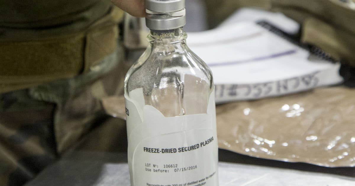 Critical Skills Operators with US Marine Corps Forces, Special Operations Command reconstitute freeze-dried plasma during a Raven exercise at Camp Shelby Joint Force Training Center. USMC Photo by Sgt. Salvador R. Moreno.