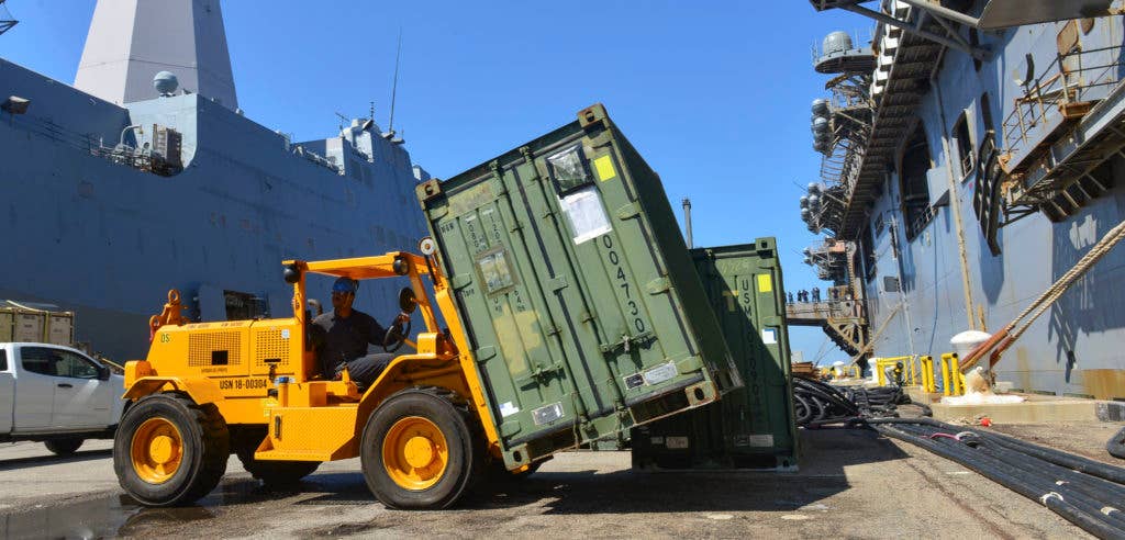 Seaman Bobby Branch moves supplies and equipment aboard the amphibious assault ship USS Iwo Jima (LHD 7) in preparation for potential humanitarian assistance and disaster relief operations. (U.S. Navy photo by Mass Communication Specialist Seaman Joe J. Cardona Gonzalez/Released)