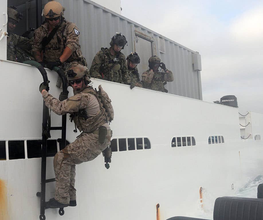 Navy SEALs assigned to a west coast based SEAL Team debark a hostile vessel off the coast of San Diego. Naval Special Warfare Boat Team (SBT) 12 assisted in the operation by providing small boat insertion and extraction to and from the boarded vessel. (U.S. Navy photo by Mass Communication Specialist 3rd Class Kristopher Kirsop/Released)