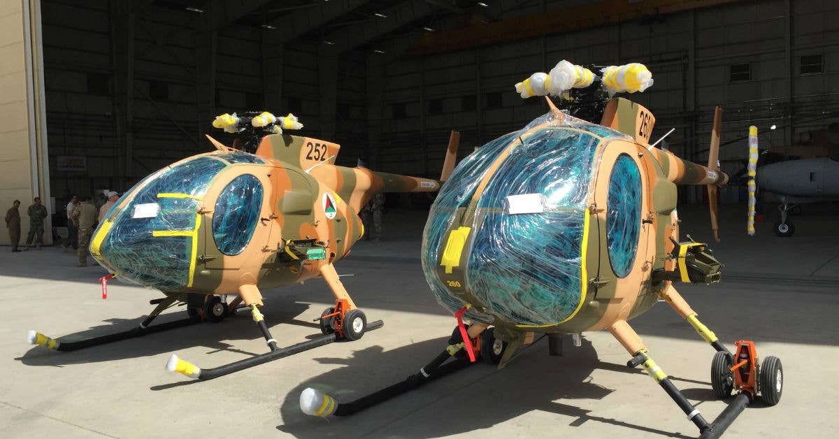 Two new MD-530 Cayuse Warrior helicopters, still with protective wrap on them. DoD photo by Lisa Ferdinando.