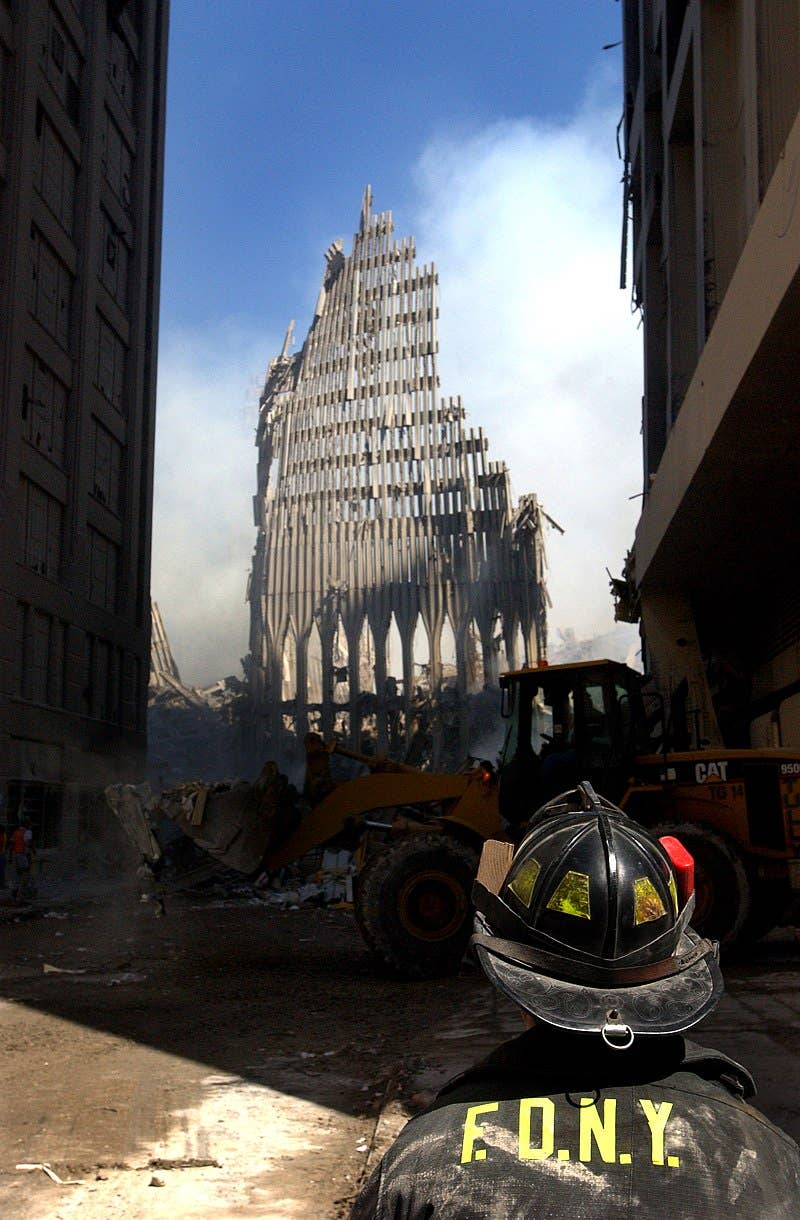 A firefighter looks at the remains of the South Tower at Ground Zero (Photo Wikimedia Commons)