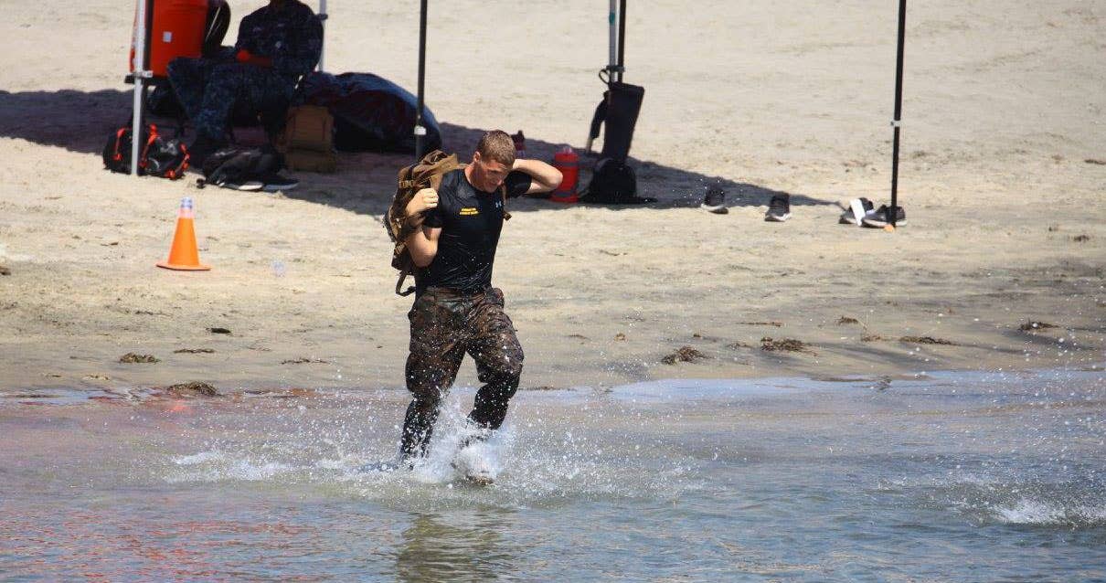 USMC Sgt. Ethan Mawhinney, a Marine Air Ground Task Force planner with US Marine Corps Forces, Special Operations Command, powers through a Tactical Water Challenge. Photo credit to MCCS Camp Pendleton.