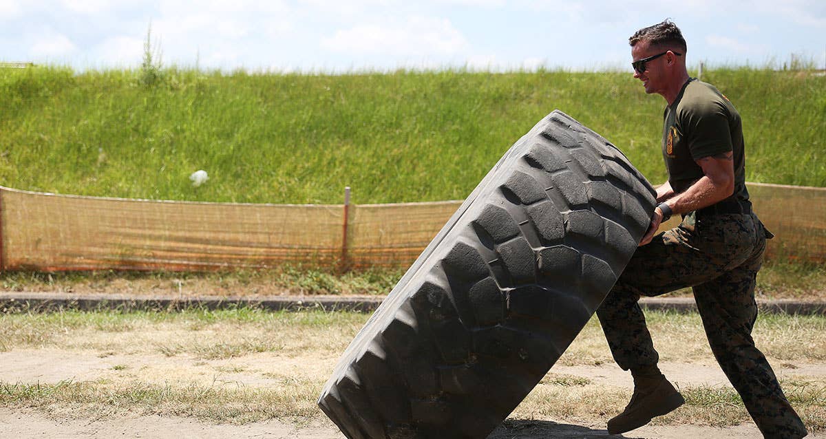 USMC Sgt. Michael Eckert, quality control chief of motor transport company, Marine Wing Support Squadron 171, flips a tire during physical training. UMSC photo by Sgt. Jessica Quezada.