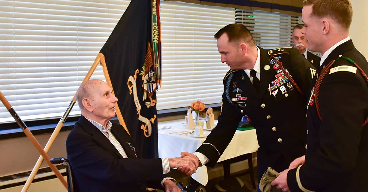 Oscar L. Davis Jr., receives a purple heart for his past service in World War II. Army photo by Capt. John. J. Moore.