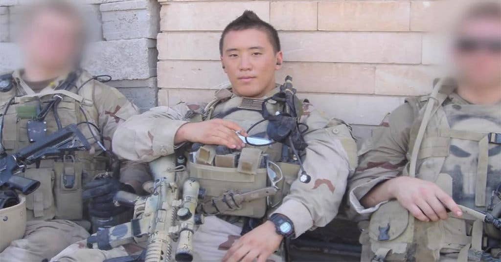 Navy SEAL Jonny Kim takes a moment for a photo op while on a combat deployment.