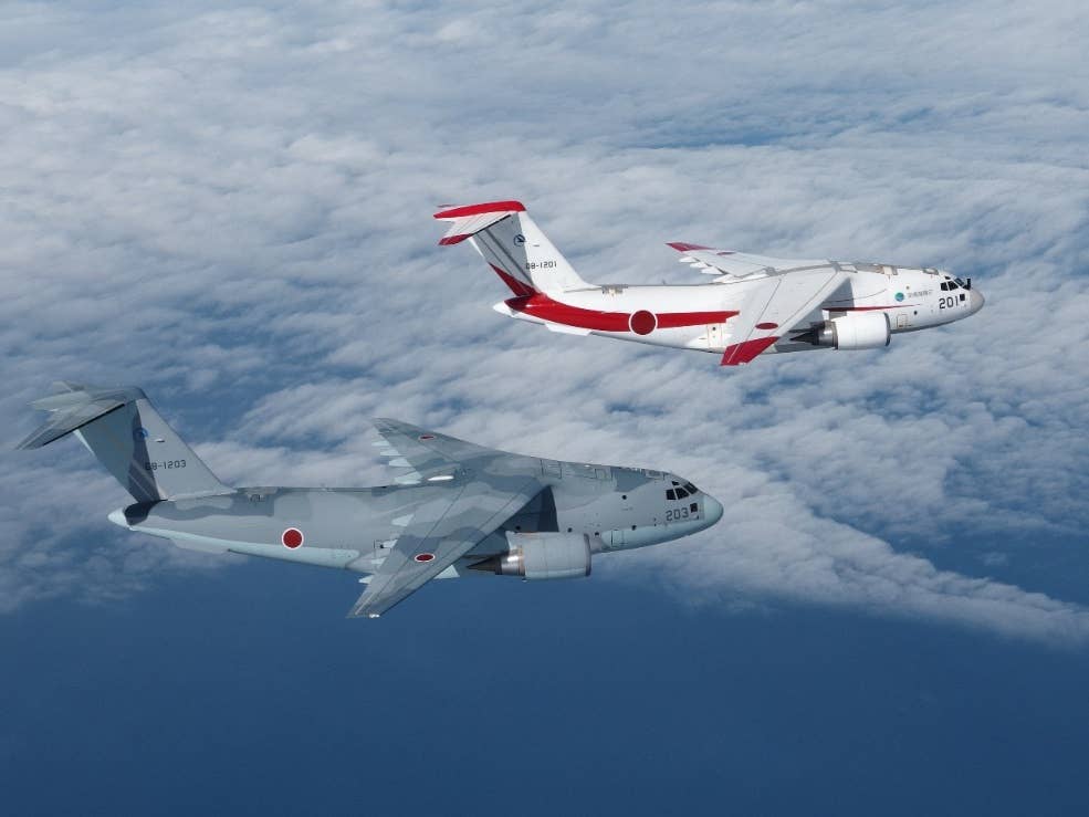 The first production and first prototype C-2s in formation. (Japanese Ministry of Defense photo)