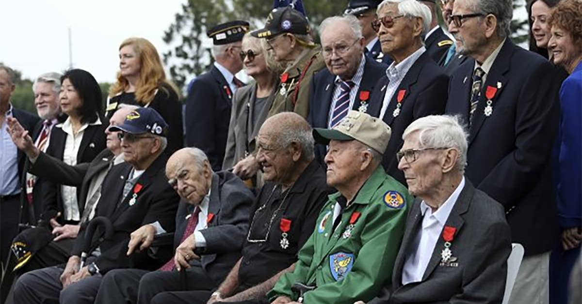 Ten California men who fought overseas with the US Army, Army Air Corps, and Marines during WWII pose after they were awarded the National Order of the Legion of Honor, during a ceremony, Sept. 19, 2017, at Los Angeles National Cemetery. Photo via Military.com