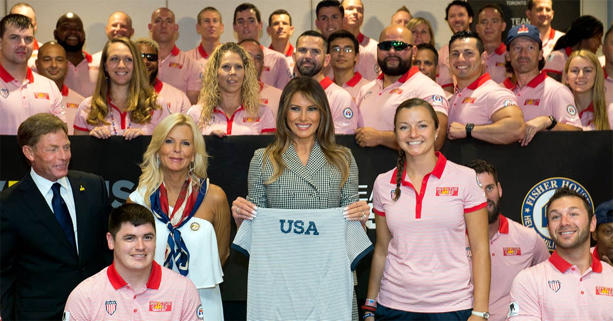 First Lady Melania Trump holds a T-shirt in support the United States competitors surrounding her before the opening ceremony for the 2017 Invictus Games in Toronto, Sept. 23, 2017. DoD photo by EJ Hersom.
