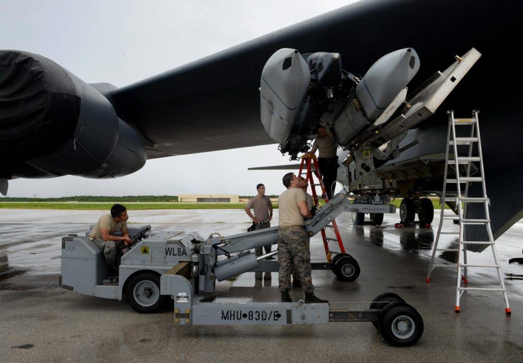 Airmen assigned to the 36th Expeditionary Aircraft Maintenance Squadron load an inert AGM-158 Joint Air-to-Surface Standoff Missile onto a B-52H Stratofortress during a munitions loading exercise July 13, 2016, at Andersen Air Force Base, Guam. (U.S. Air Force photo by Airman 1st Class Alexa Ann Henderson)