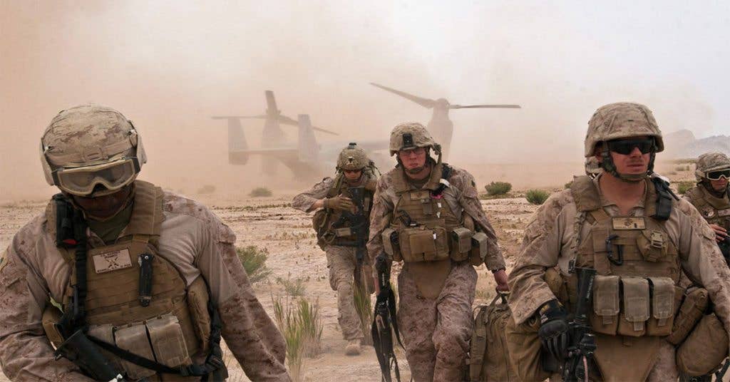 These Marines prepare to get into the sh*t after exiting an Osprey helicopter.