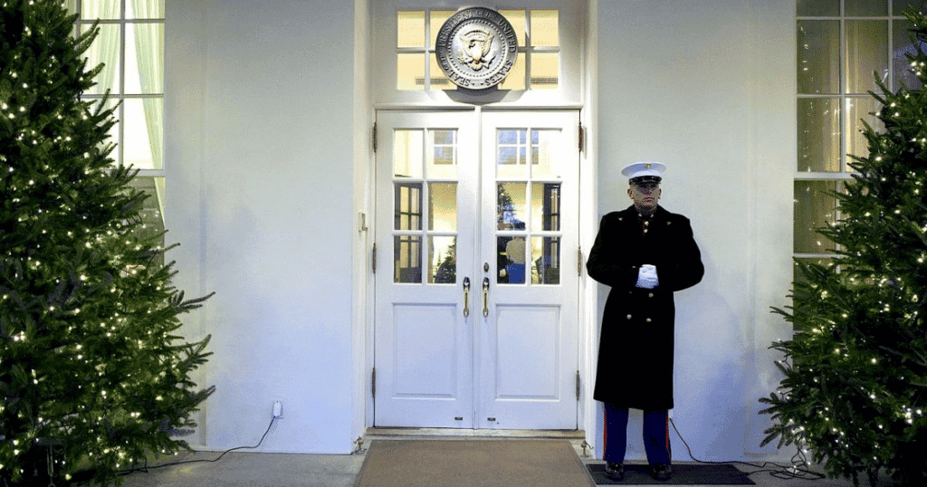 This Marine stands guard outside the West Wing door in the December cold. (Source: Wikipedia Commons)