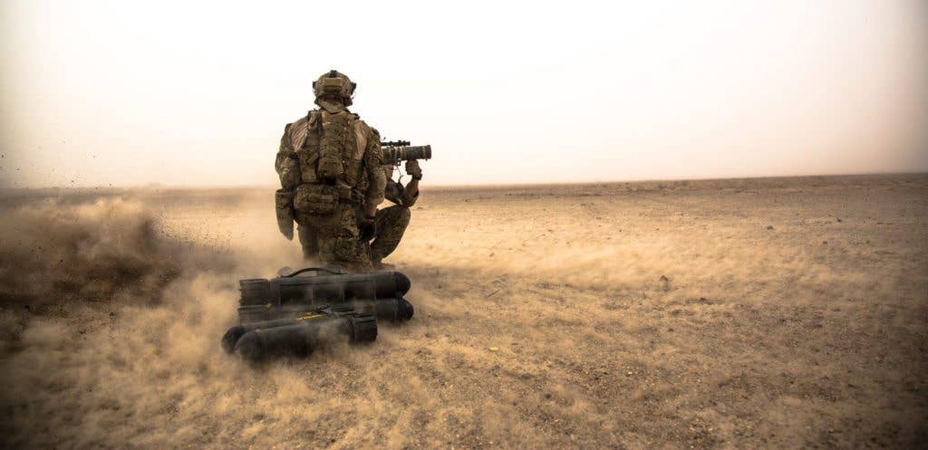 A coalition force member observes as a soldier shoots a Carl Gustav recoilless rifle at a range in Helmand province, Afghanistan, Aug. 16, 2013. Coalition force members train at ranges regularly to maintain weapon readiness for operations. (U.S. Army photo by Spc. Justin Young)