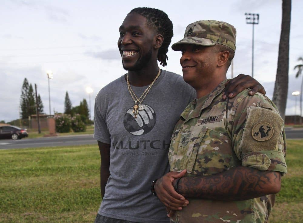 LA Clippers' Point Guard, Patrick Beverley, taking a photo with troops (Photo by Petty Officer 1st Class Meranda Keller)