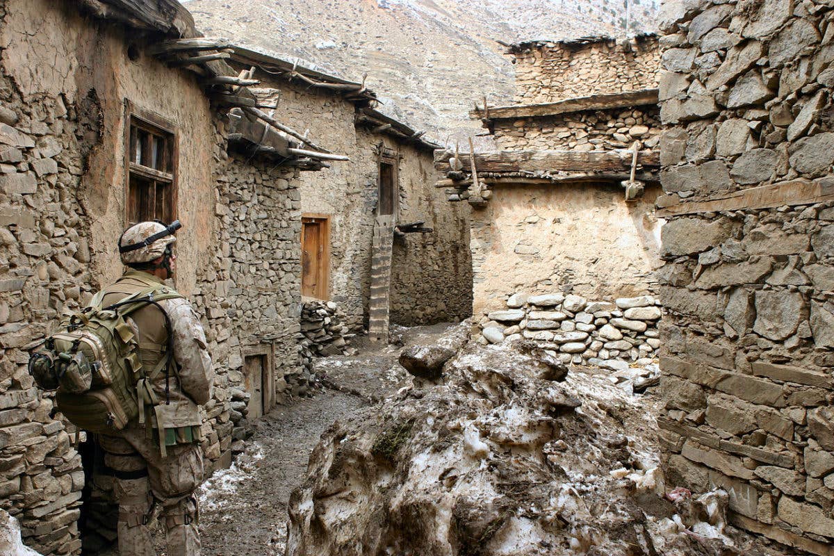 A U.S. Navy Corpsman searches for Taliban fighters in the spring of 2005. | US Marine Corps photo