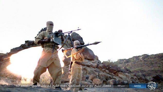 Two ISIS recruits operate their weapons, a RPG (right) and a PKM (left). (ISIS photo)