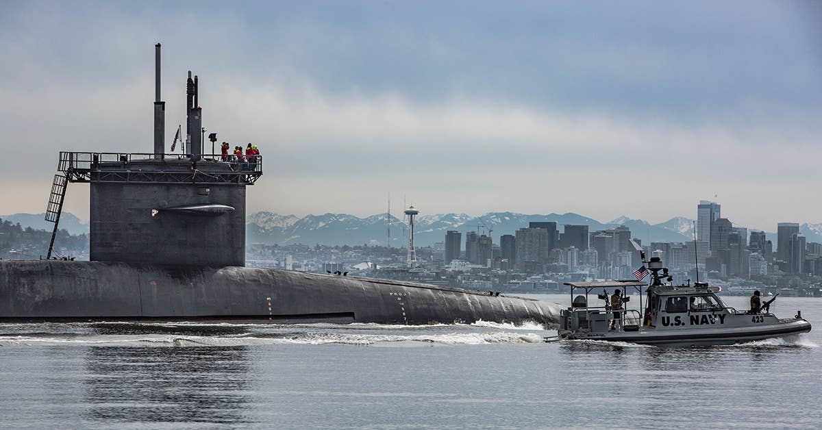 The guided-missile submarine USS Ohio (SSGN 726) transits the Puget Sound on its way to Puget Sound Naval Shipyard and Intermediate Maintenance Facility to commence a Major Maintenance Period. Navy photo by Chief Mass Communication Specialist Paul Seeber.