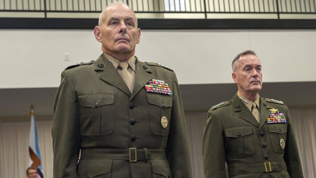 U.S. Marine Gen. John F. Kelly, left, and Marine Corps Gen. Joseph F. Dunford, chairman of the Joint Chiefs of Staff, stand at attention. (U.S. Marine Corps photo)