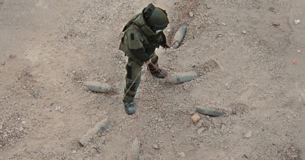 Ssgt. William James pulls on a daisy chain of IEDs as he preps to defuse them. (Source: Summit Entertainment)