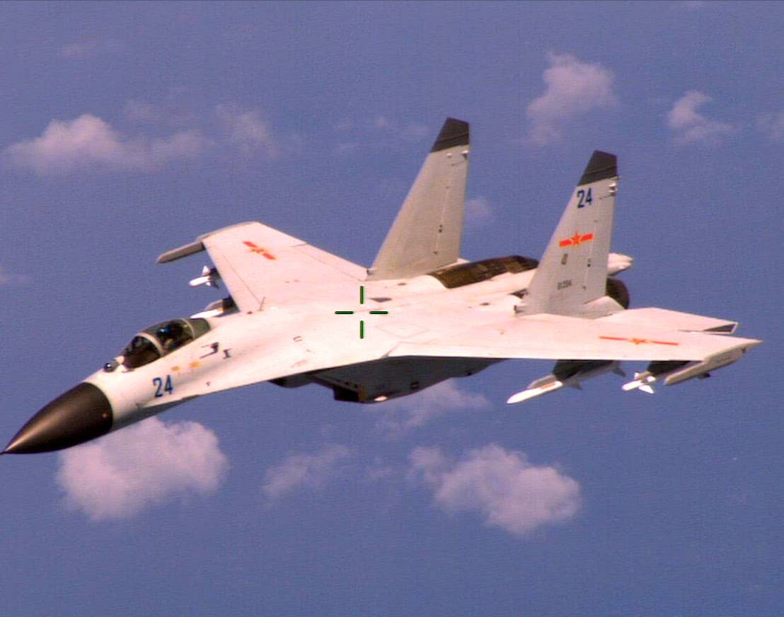 An armed Chinese fighter jet flies near a U.S. Navy P-8 Poseidon patrol aircraft over the South China Sea about 135 miles east of Hainan Island in international airspace. (U.S. Navy Photo)