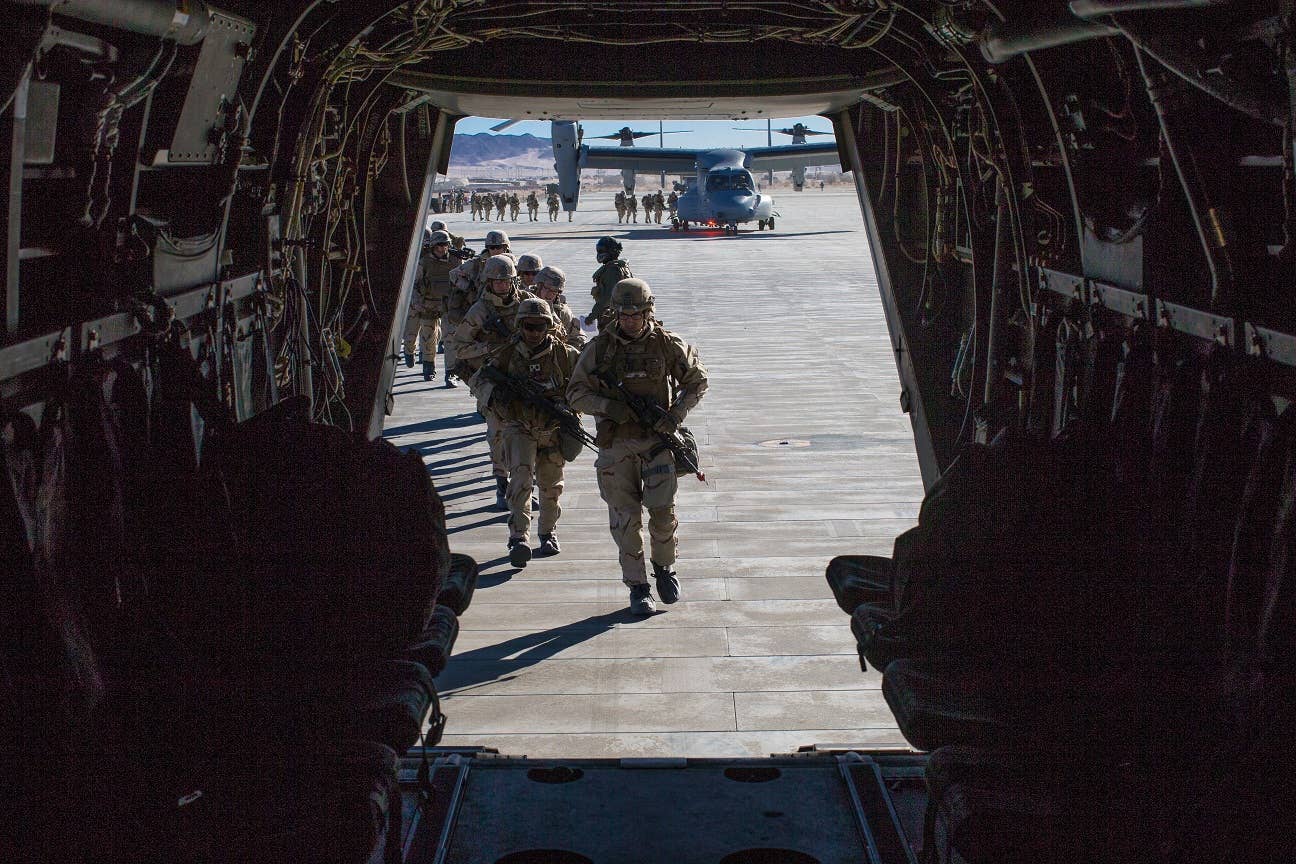 Marines with 2nd Battalion, 5th Marine Regiment (2/5), 1st Marine Division, prepare to board an MV-22B Osprey with Marine Medium Tiltrotor Squadron (VMM) 364 during a training mission in support of Exercise Winter Fury 18 at Marine Corps Air-Ground Combat Center Twentynine Palms, Calif., Dec. 7. (U.S. Marine Corps photo by Lance Cpl. Nadia J. Stark)