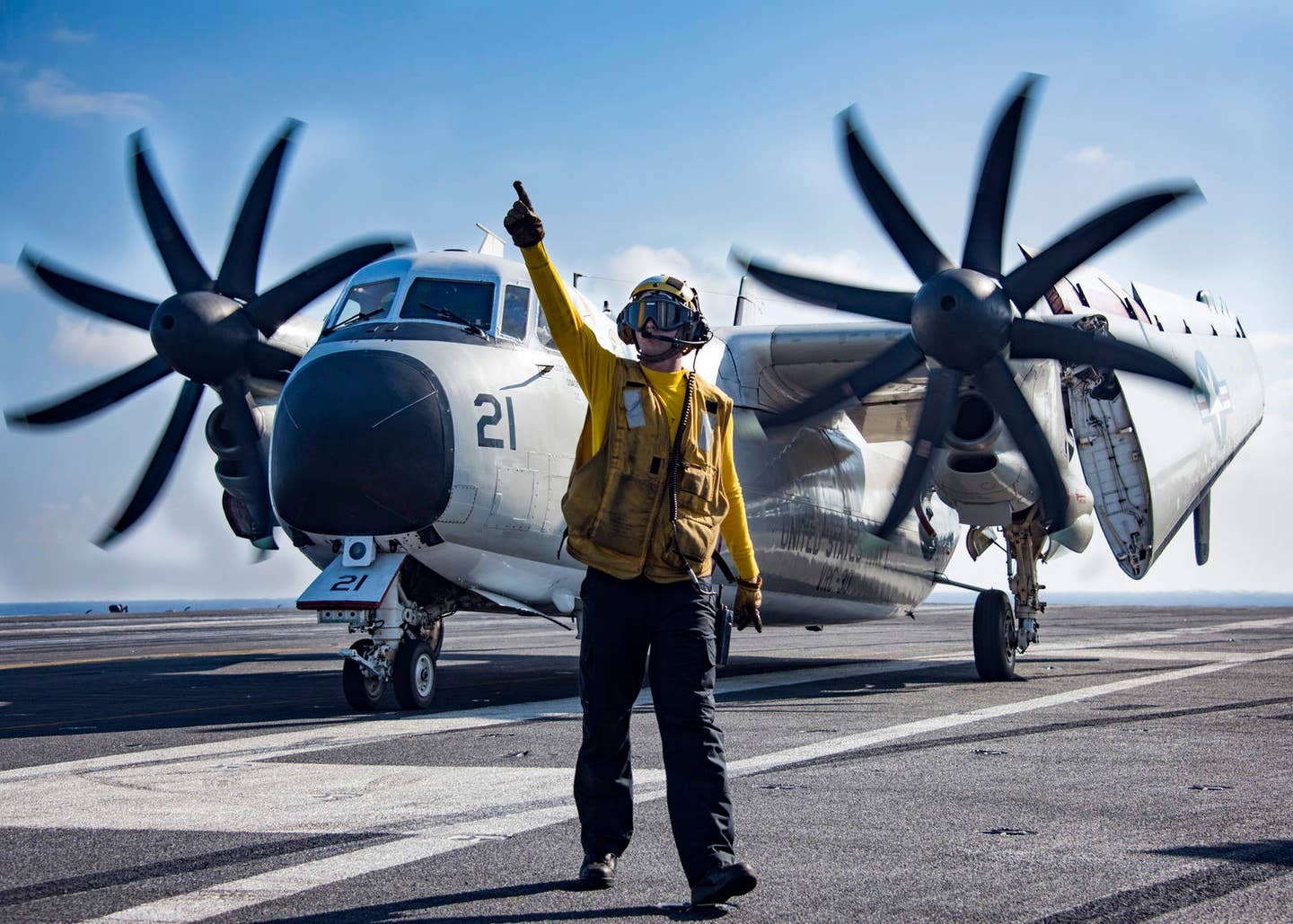 Aviation Boatswains Mate (Handling) 3rd Class Dylan Mills directs the crew of a C-2A Greyhound from Fleet Logistics Support Squadron (VRC) 30 aboard the aircraft carrier USS Carl Vinson (CVN 70). (U.S. Navy Photo by Mass Communication Specialist 2nd Class Sean M. Castellano)