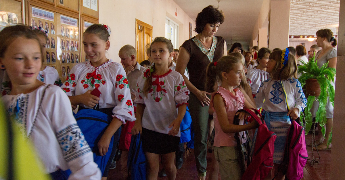 Ukrainian school children smile as they carry away their new backpacks Aug. 31, 2015. (U.S. Army photo by Sgt. Alexander Skripnichuk, 13th Public Affairs Detachment)