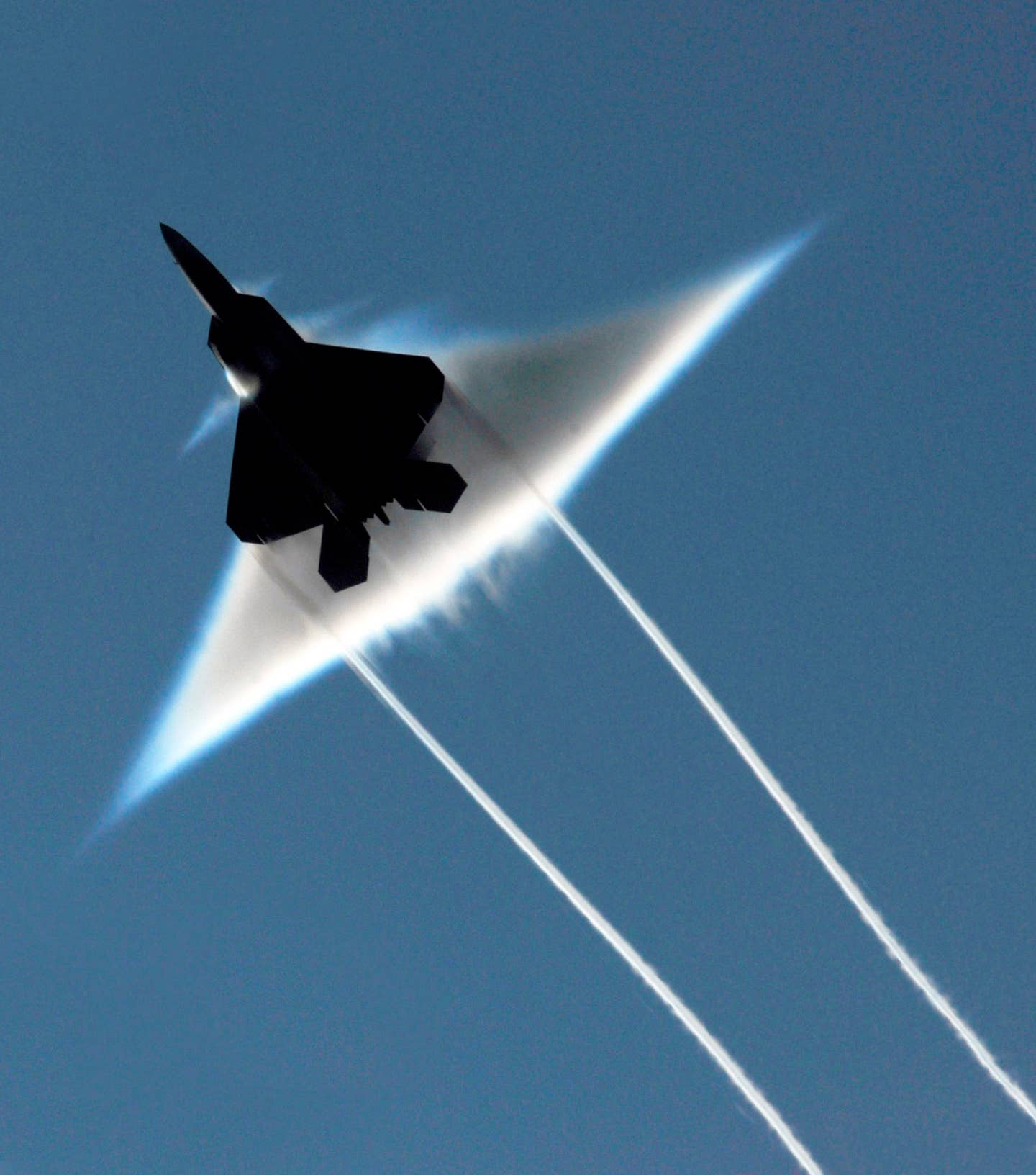 An Air Force F-22 Raptor executes a supersonic flyby over the flight deck of the aircraft carrier USS John C. Stennis (CVN 74). John C. Stennis is participating in Northern Edge 2009, a joint exercise focusing on detecting and tracking units at sea, in the air and on land. (U.S. Navy photo by Sonar Technician (Surface) 1st Class Ronald Dejarnett)