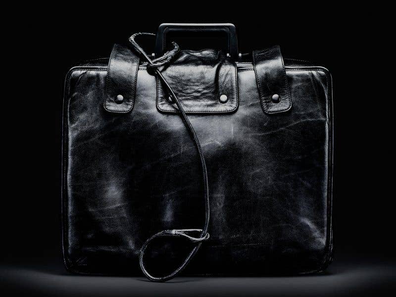 The nuclear football (also known as the atomic football, the president's emergency satchel, the button, the black box, or just the football) is a briefcase, the contents of which are to be used by the President of the United States to authorize a nuclear attack while away from fixed command centers, such as the White House Situation Room. (Image from Wikimedia Commons)