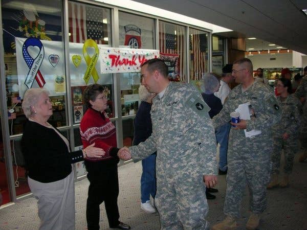 Odd how a handshake or a warm hug can make a difference to hardened war fighters. (Photo by Sgt. 1st Class Clinton Wood)