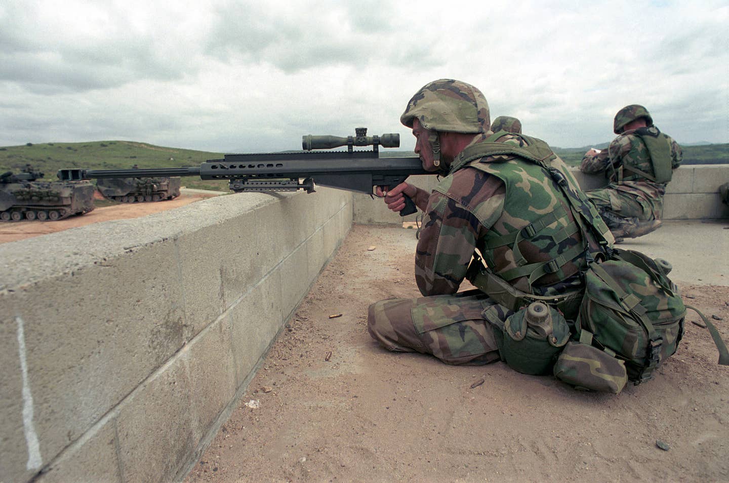 US Marine Corps (USMC) Corporal (CPL) Joe Rattlif sites through the scope mounted to a 12.7mm .50 in Barrett Light Fifty Model 82A1 sniping rifle, while training at the Military Operations in Urban Terrain (MOUT) facility, Camp Pendleton, California (CA), during Exercise KERNEL BLITZ 2001. (USMC photo)