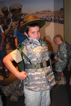 Anyone feel like telling the kids that wearing a Drill Sergeant's campaign hat will curse them into becoming Drill Sergeants one day? No? Okay! (Image via National Infantry Museum)