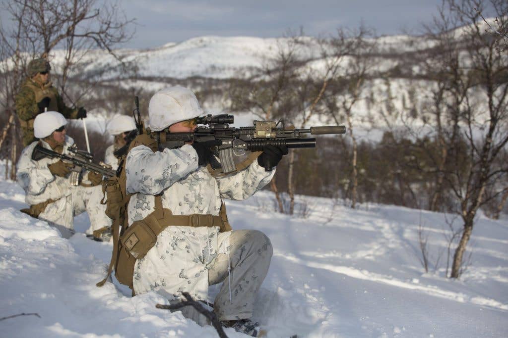 U.S. Marine Cpl. Chris Bastian with Marine Rotational Force Europe (MRF-E) uses a suppressor to conduct live-fire range in preparation for exercise Joint Viking, in Porsangmoen, Norway, March 2, 2017. (U.S. Marine Corps photo by Lance Cpl. Victoria Ross)