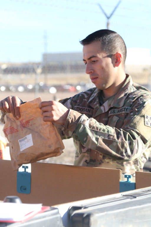 Spc. Basar Bozdogan, an automated logistical specialist for Alpha Company, 64th Brigade Support Battalion, 3rd Armored Brigade Combat Team, 4th Infantry Division, sorts through supplies Jan. 9, 2018. (U.S. Army photo by Staff Sgt. Ange Desinor)