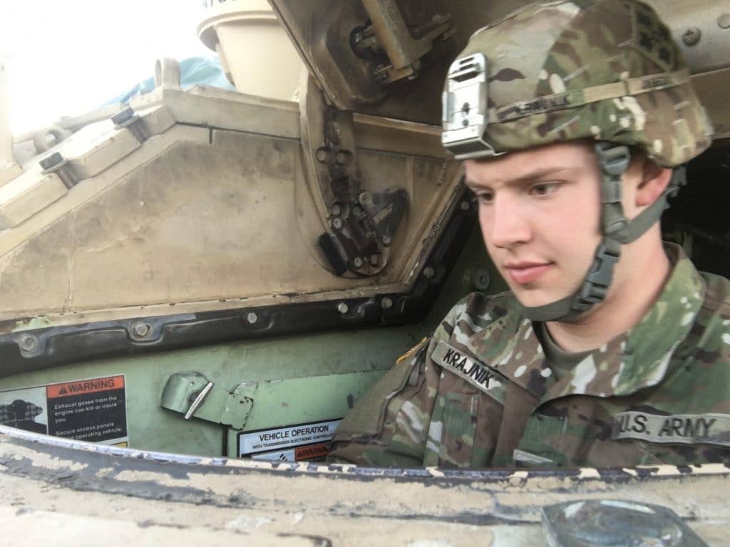 Pfc. Jacob Kranjnik, an infantryman, for Alpha Company, 1st Battalion, 68th Armor, 3rd Armored Brigade Combat Team, 4th Infantry Division, conducts maintenance on his Bradley Fighting vehicle, ensuring its readiness for upcoming missions, Fort Carson, Colorado, January 9, 2018. Kranjnik and his fellow Soldier Spc. Basar Bozdogan are credited with saving a civilian from a burning car wreck, Sept. 3, 2017. (Photo from U.S. Army)